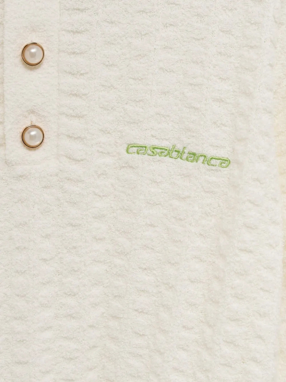 Polo con bottoni e trama in rilievo